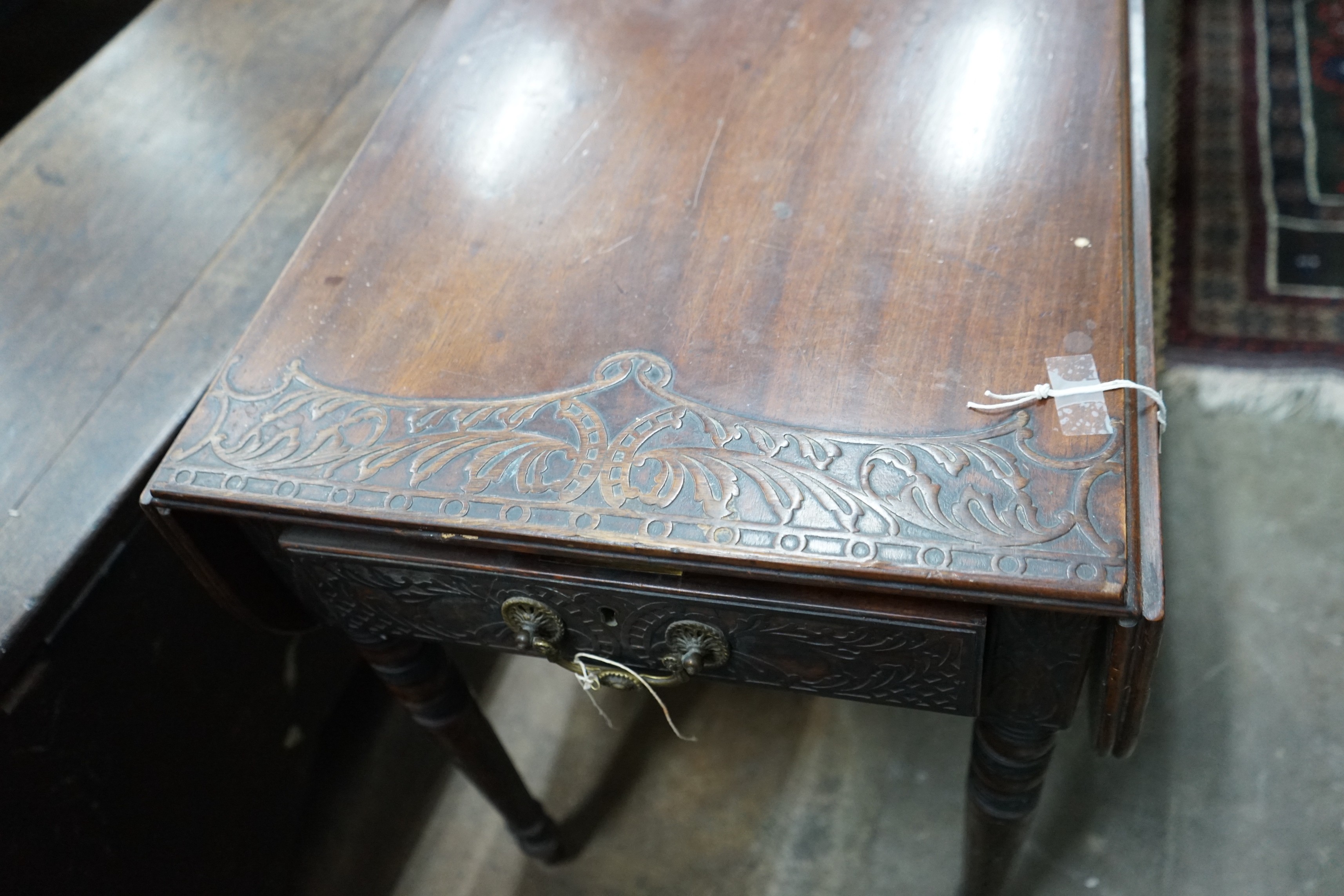 A Regency mahogany Pembroke table, later carved, width 89cms, depth 47cms, height 66cms.